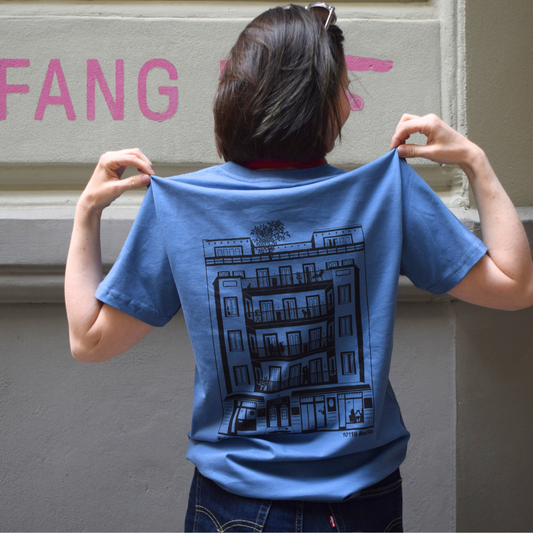 Blue T-shirt featuring the GORKI logo on the front and our building on the back